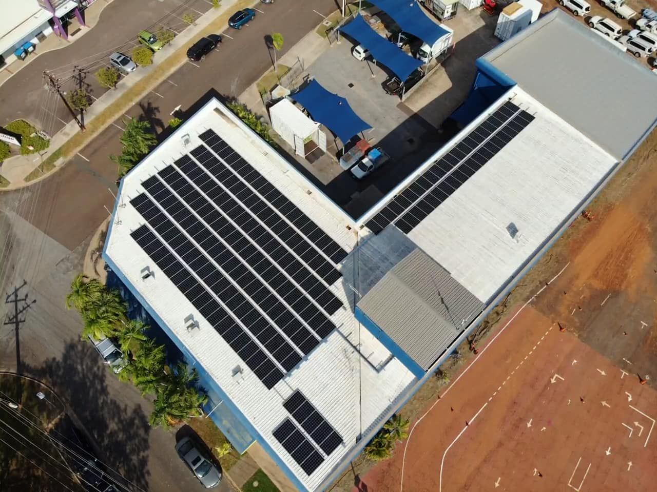 An Aerial View of a Building With Solar Panels on the Roof — Eco Sparks Solar & Electrical Contractors in Berrimah, NT