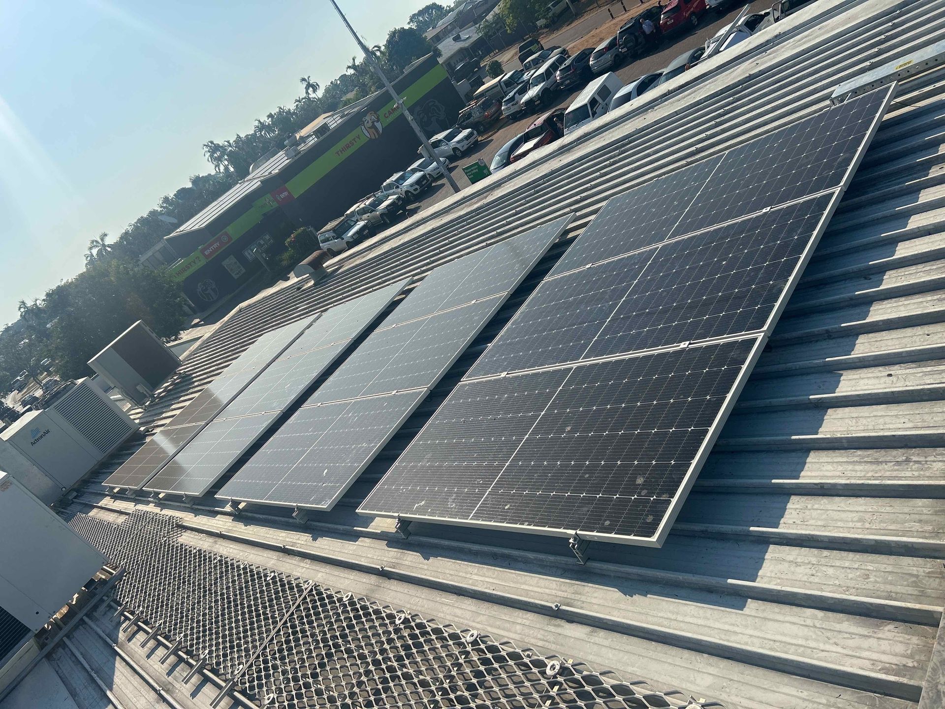 A Row of Solar Panels Sitting on Top of A Tiled Roof — Eco Sparks Solar & Electrical Contractors in Berrimah, NT