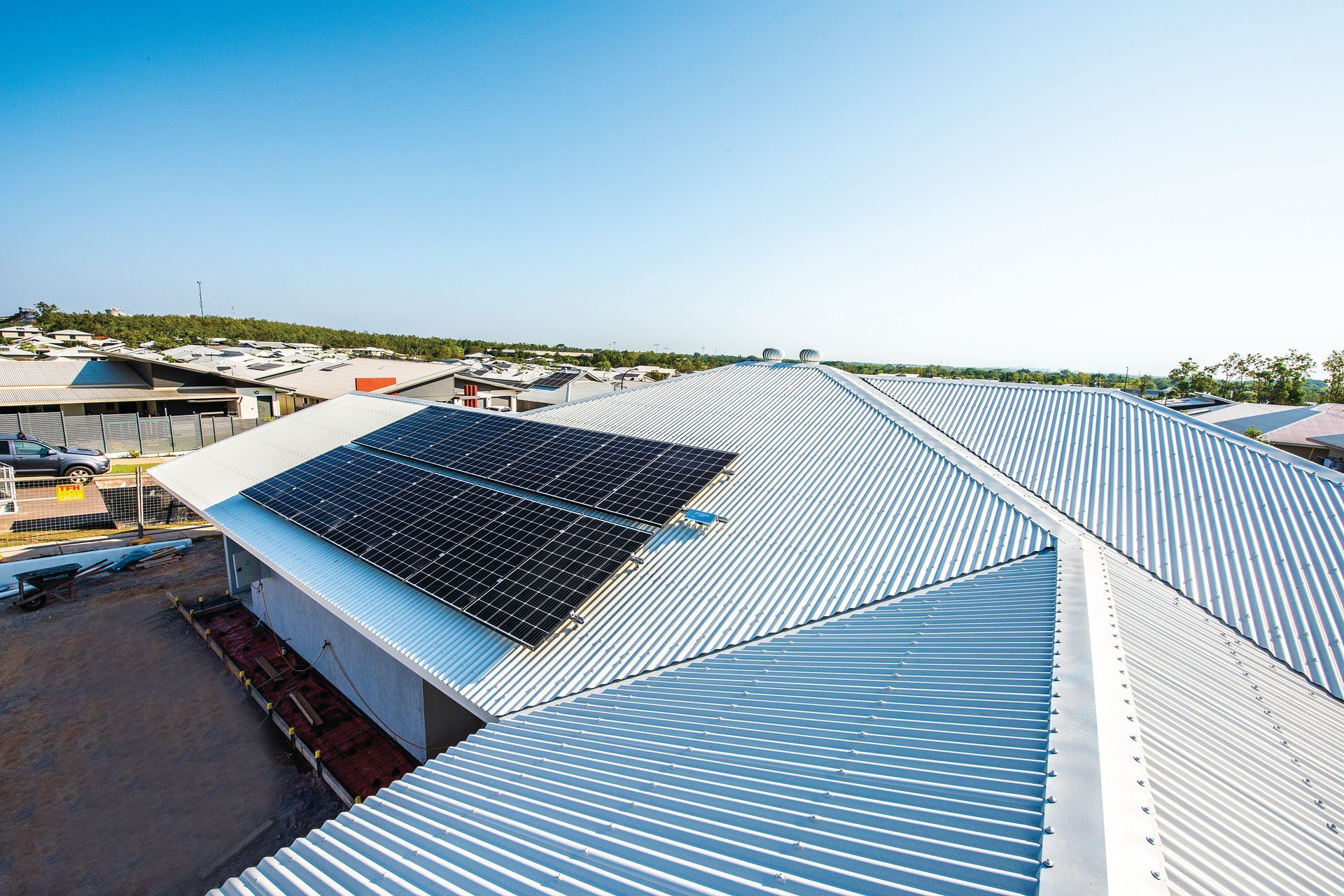 A Solar Panel Is Sitting in Front of A Water Tank — Eco Sparks Solar & Electrical Contractors in Berrimah, NT