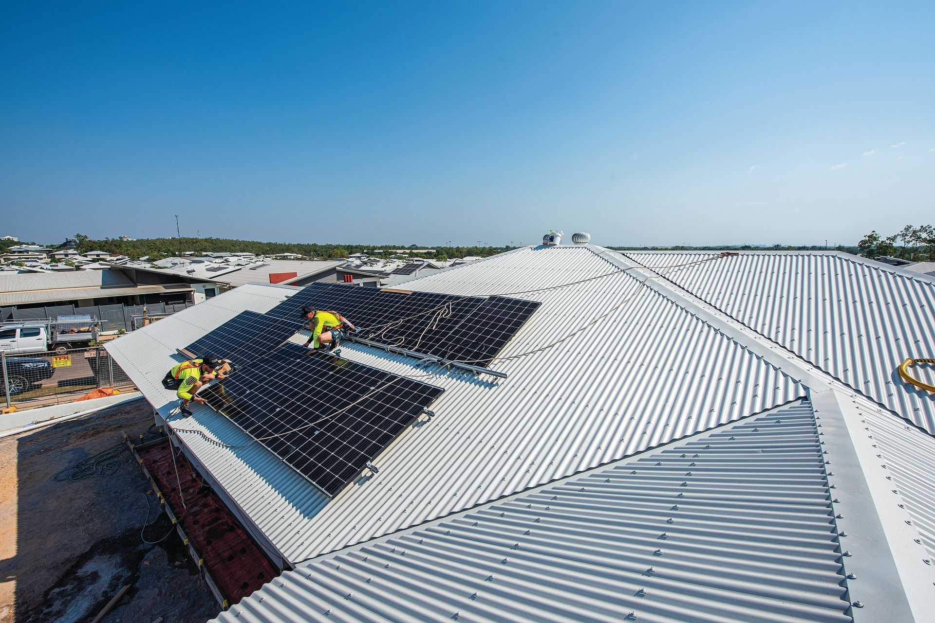 A Row of Solar Panels on The Roof of A Building — Eco Sparks Solar & Electrical Contractors in Berrimah, NT