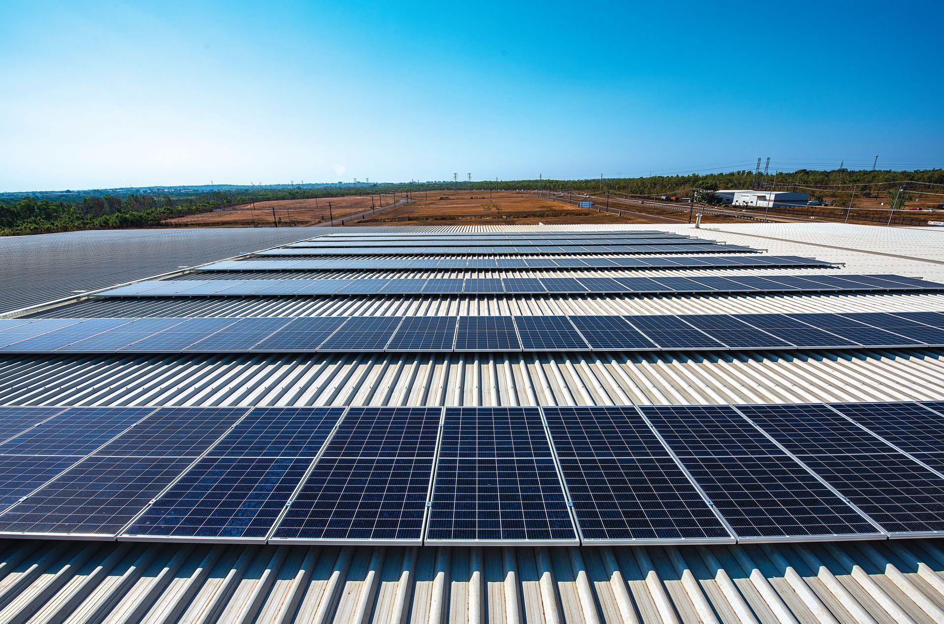 The Sun Is Shining Through the Solar Panels on The Roof of A House — Eco Sparks Solar & Electrical Contractors in Berrimah, NT