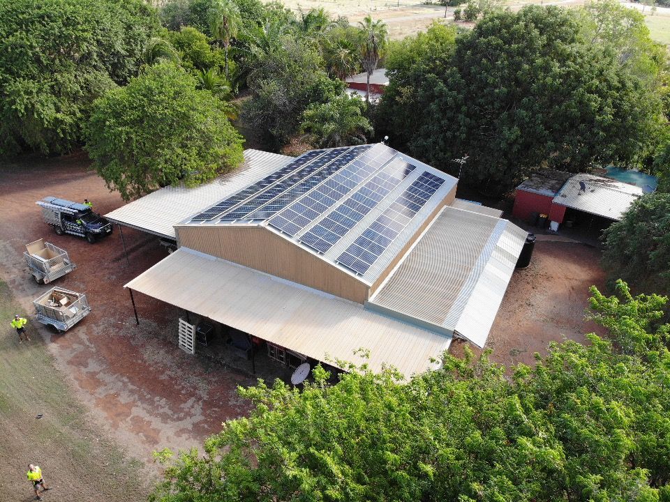 A White House with A Balcony and Solar Panels on The Roof — Eco Sparks Solar & Electrical Contractors in Berrimah, NT