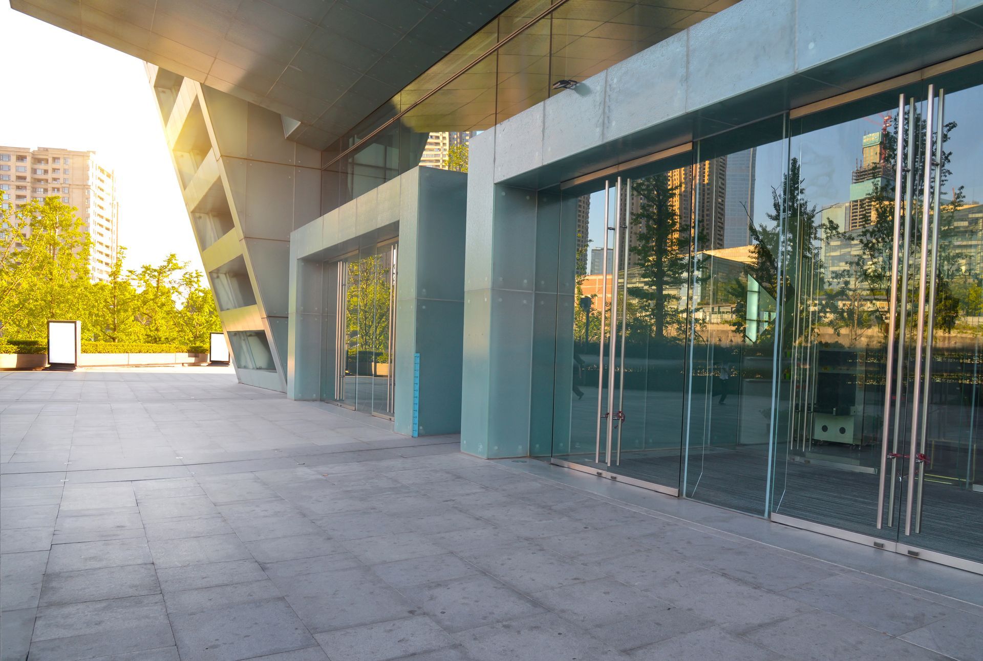 A large building with a lot of glass doors and a concrete floor.