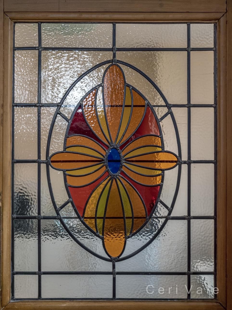 A stained glass window with a flower design on it