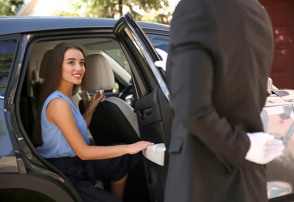 Driver Opening Car Door For Young Businesswoman — Private Car Transport In Cairns, QLD