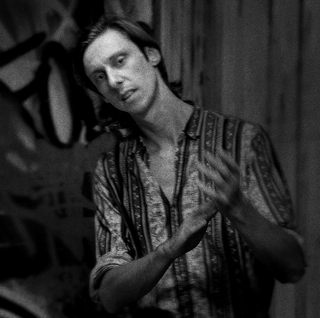 Professional Portrait shot by Stu Spence as part of an album art project. Photograph shows a man dressed in a casual shirt captured in black and white