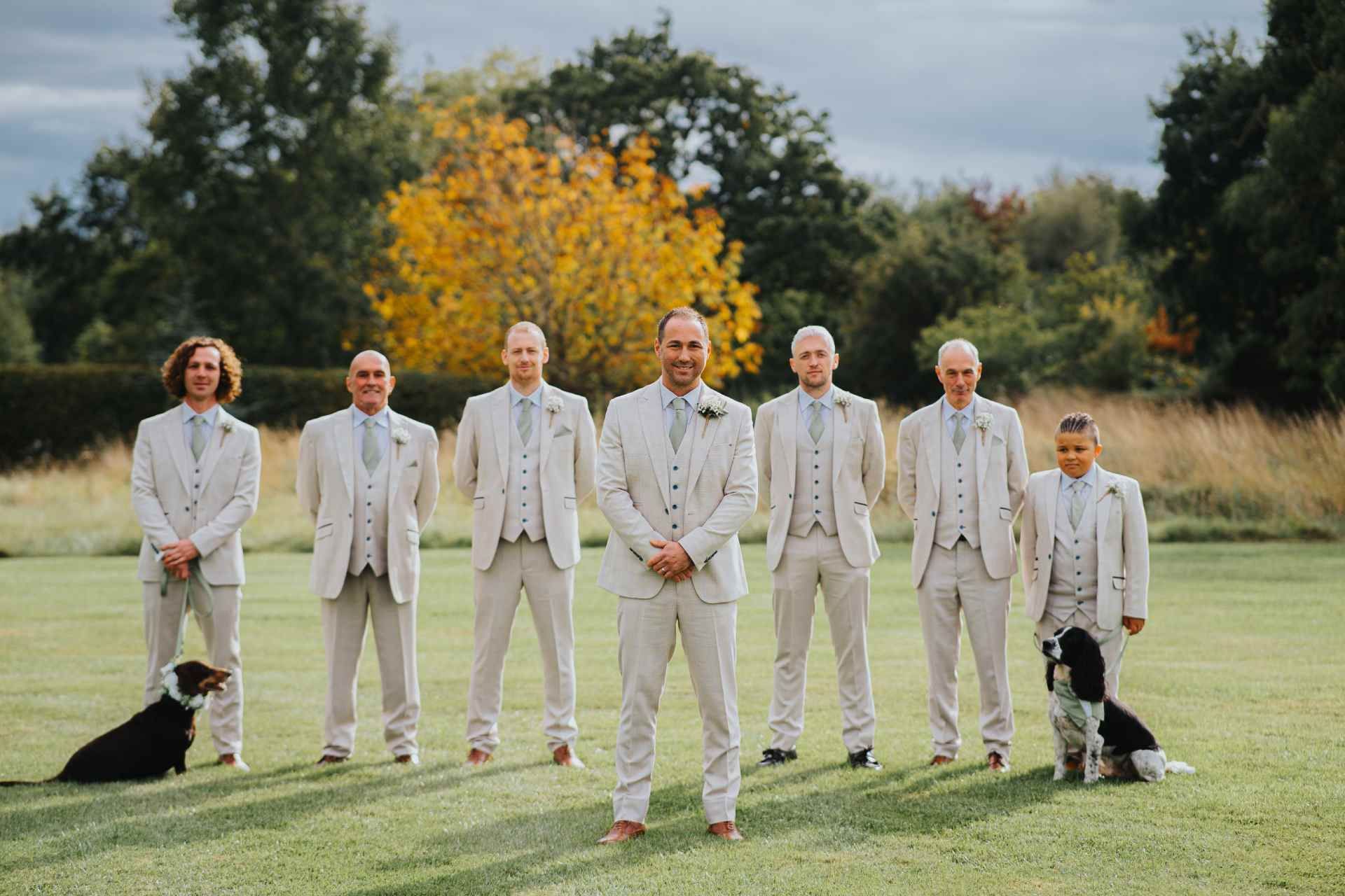 groom and best man with groomsmen and dogs at Wooten park