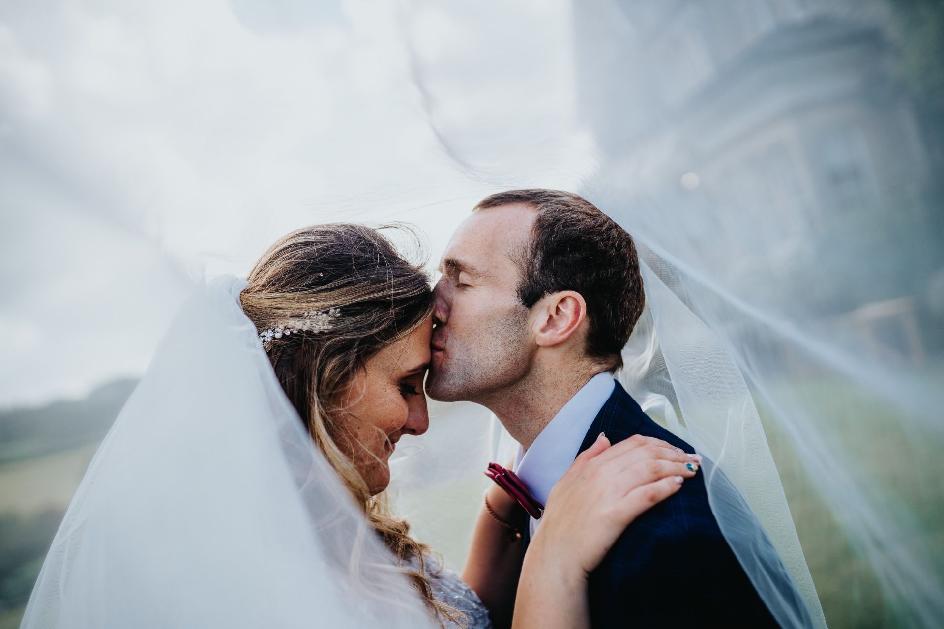 bride and groom close up with vale 