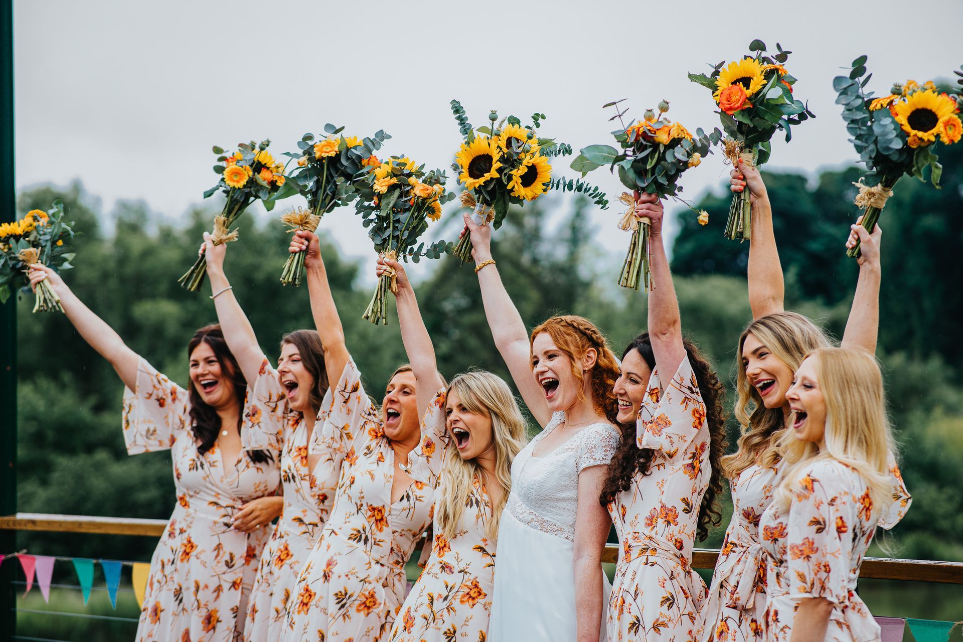 wedding party celebrating wiht flowers in the air 