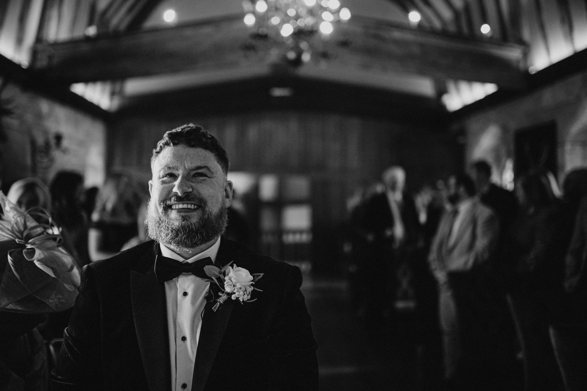 black and white shot of groom waiting for his bride 