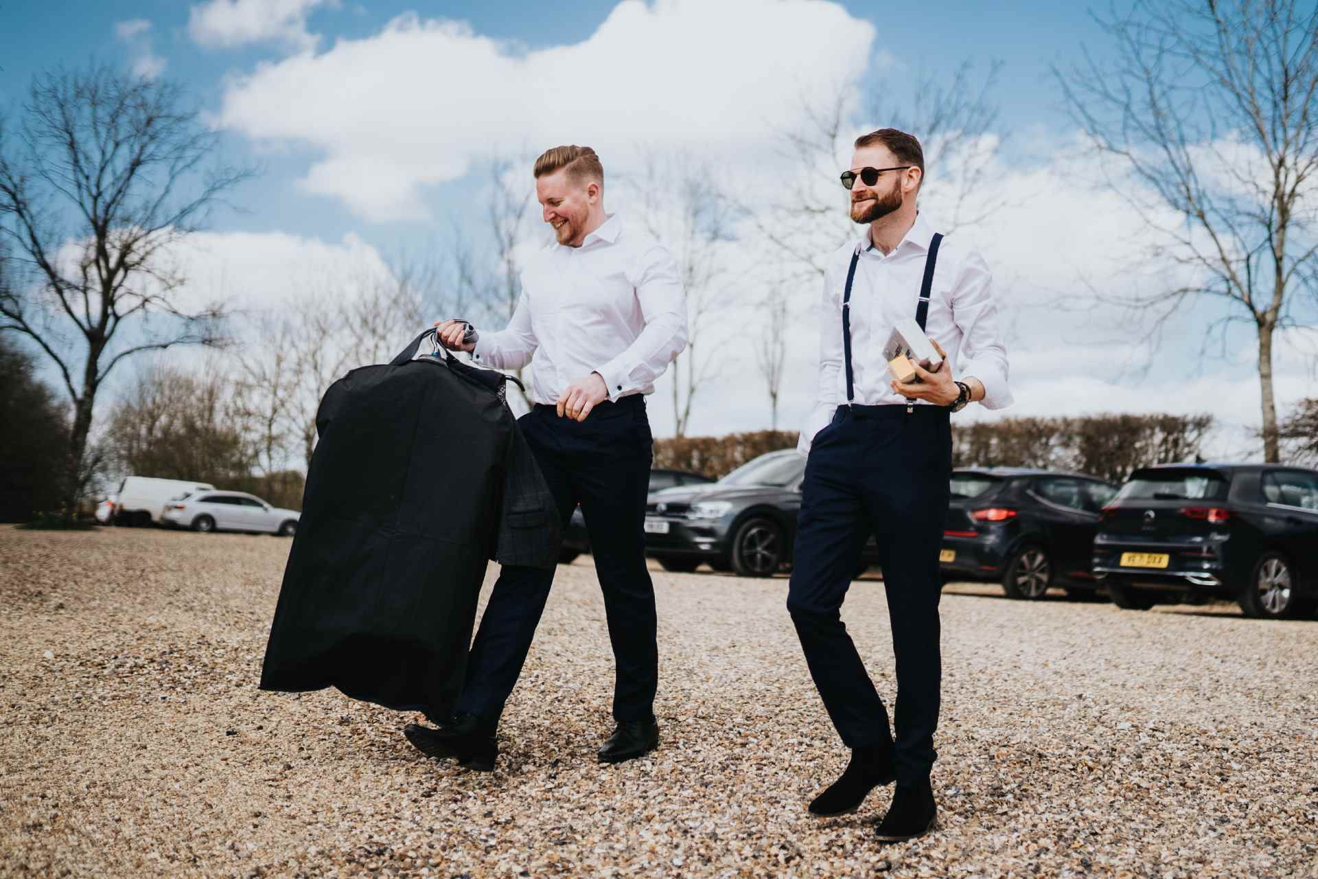 groom and best man with suits at barn wedding 