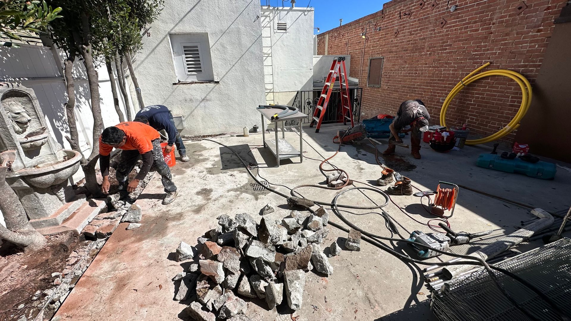A Group of Construction Workers Are Working in A Backyard