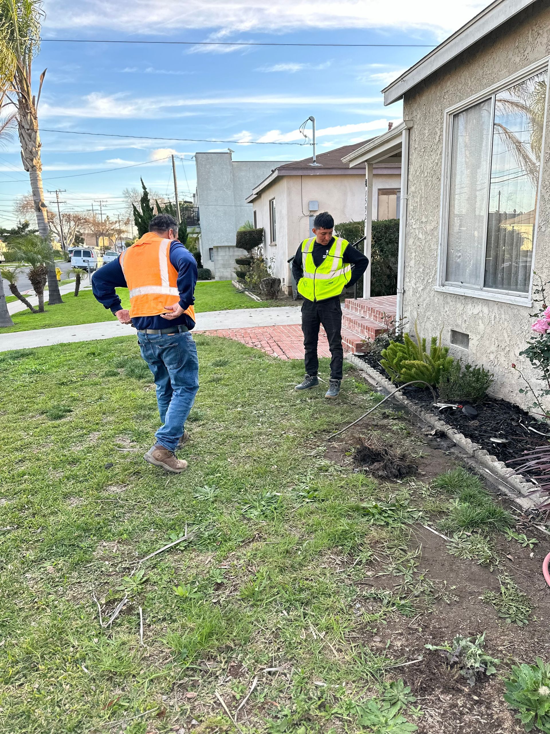 Two Men In Safety Vests Inspecting A House - Anaheim, CA - J & L Plumbing Services