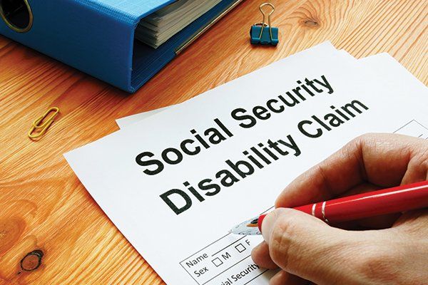 Man Filling in Social Security Disability Claim — Elmira, NY — Hutchison & Bocek