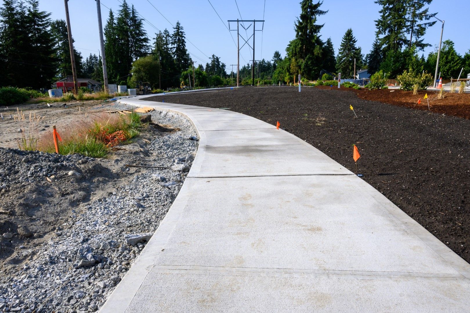 A concrete walkway going through a gravel area