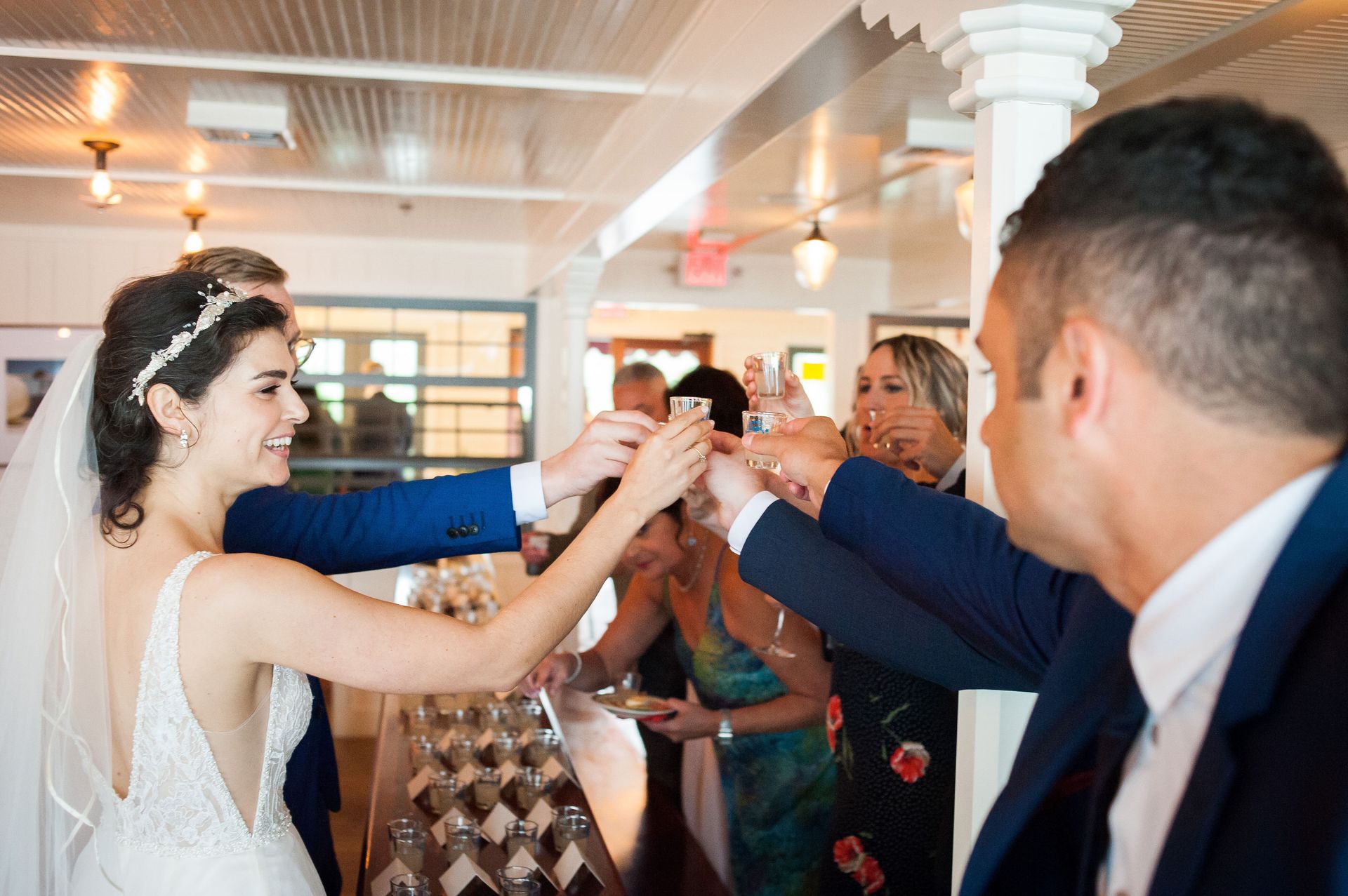 Bride and groom toasting with champagne during a wedding reception.