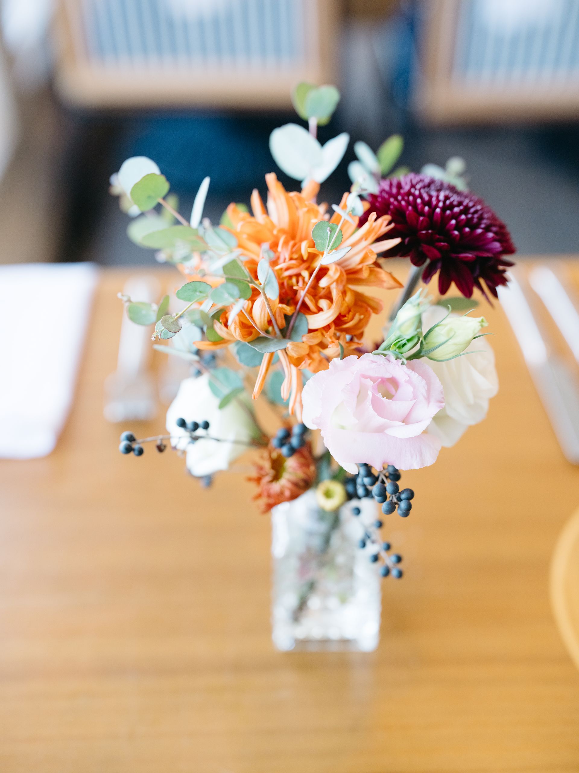 A long table with a vase of flowers on it.