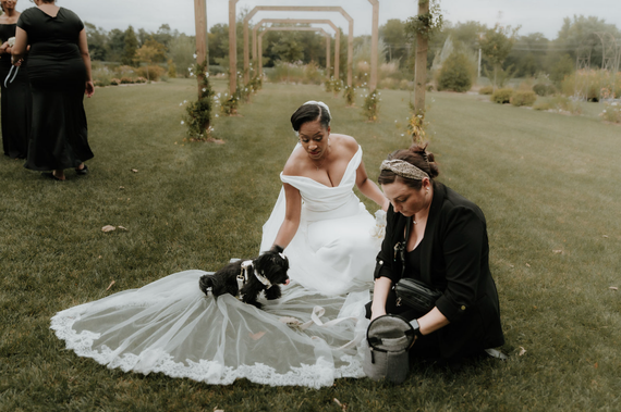 A woman is sitting on a wooden bench in a restaurant.