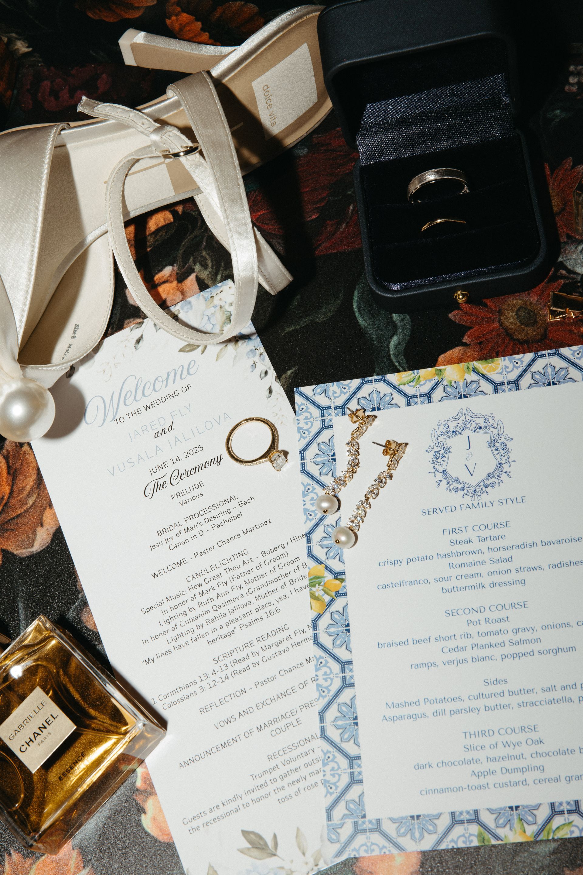 Wedding details: rings in box, shoes, earrings, perfume, invitations, and floral print.