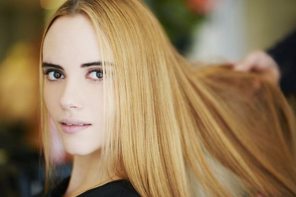 Close up portrait woman with strawberry blonde hair in salon
