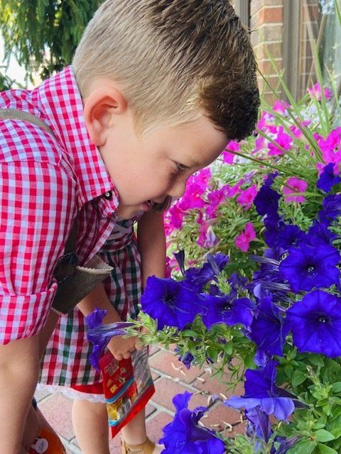 Boy Smelling A Flower — Jasper, IN — Schnitzelbank Restaurant