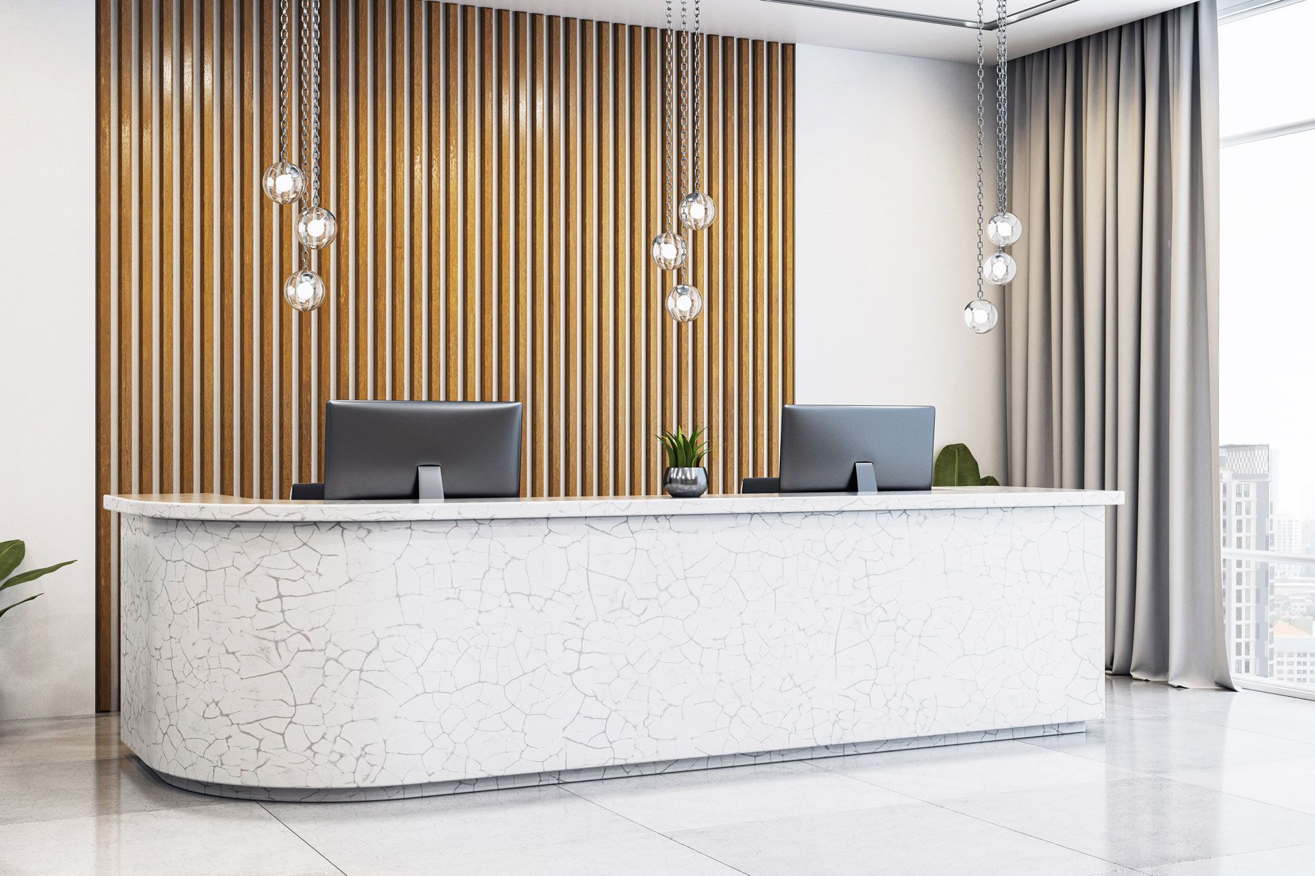 Modern reception area with white curved desk, computers, and gold slatted wall backdrop.