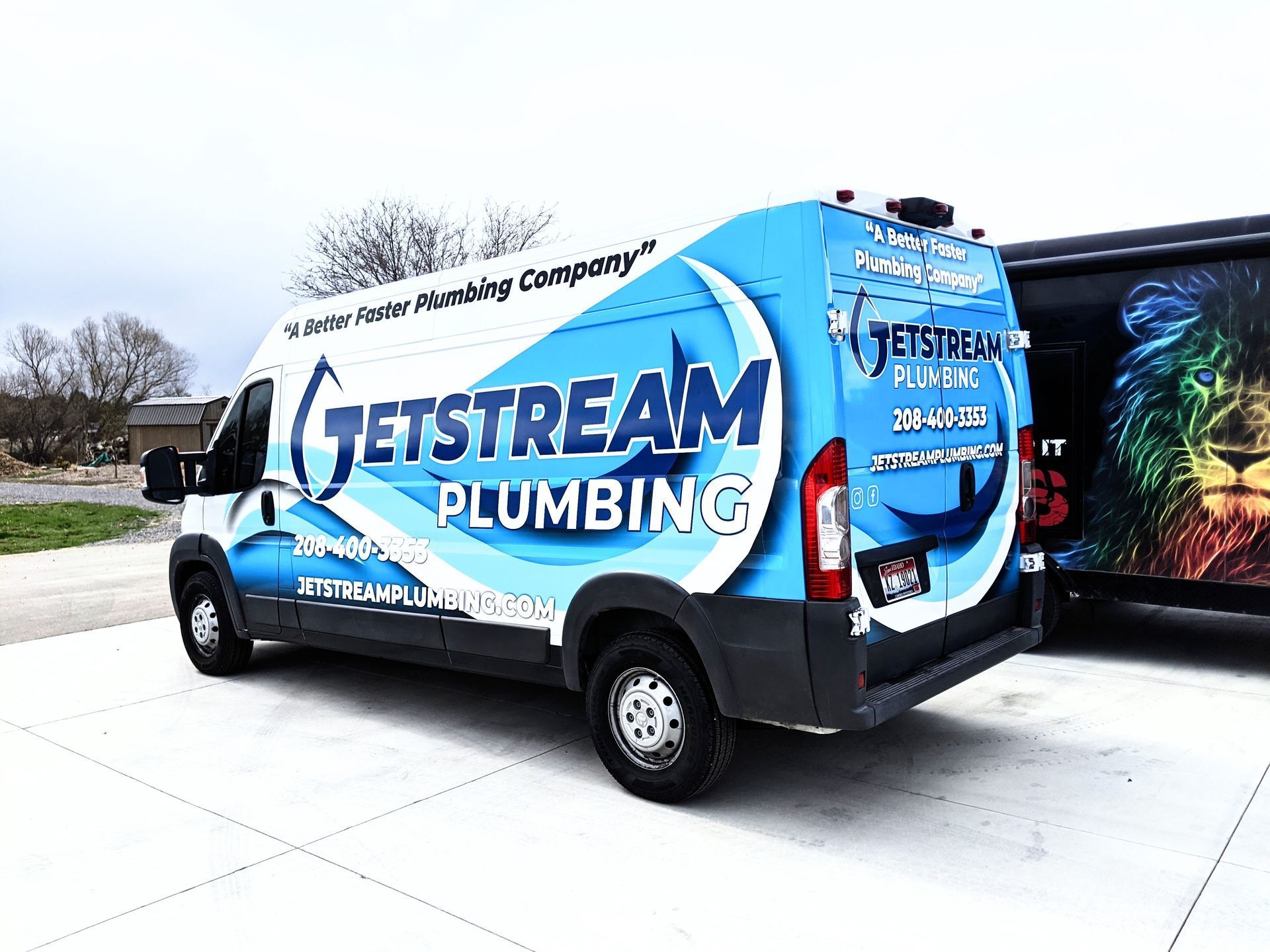 A jetstream plumbing van is parked in a parking lot.