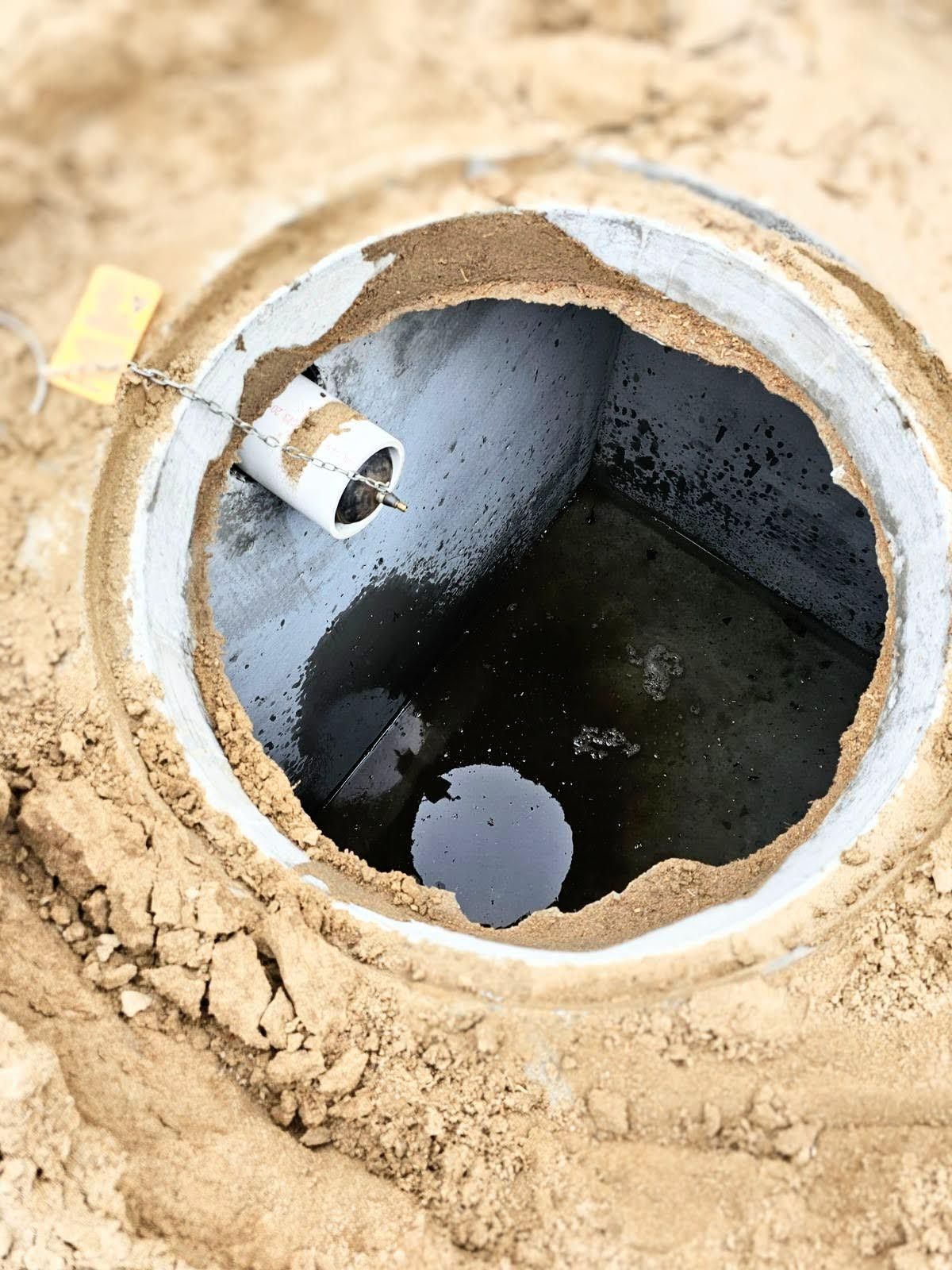 A hole in the ground with water coming out of it.