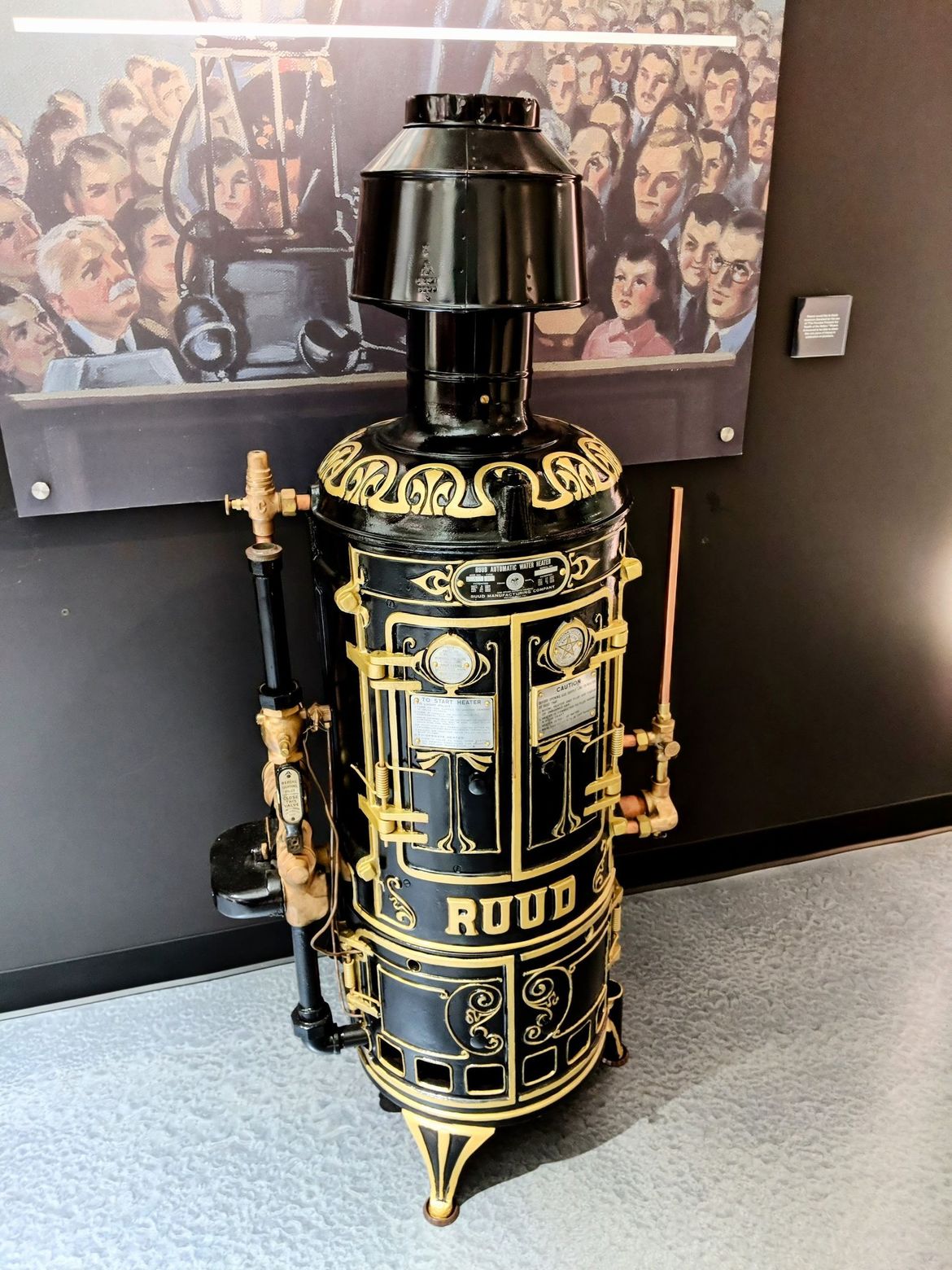 A black and gold stove with the word rood on it