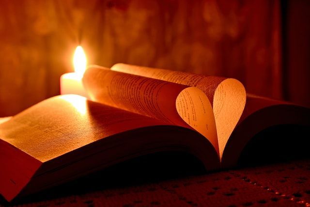 Open book with candlelight forming a heart shape in Milwaukee, WI