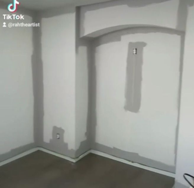 A room that is being painted with tiktok written on the bottom
