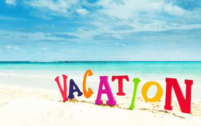 Colorful “VACATION” letters on a sunny beach with turquoise ocean and blue sky