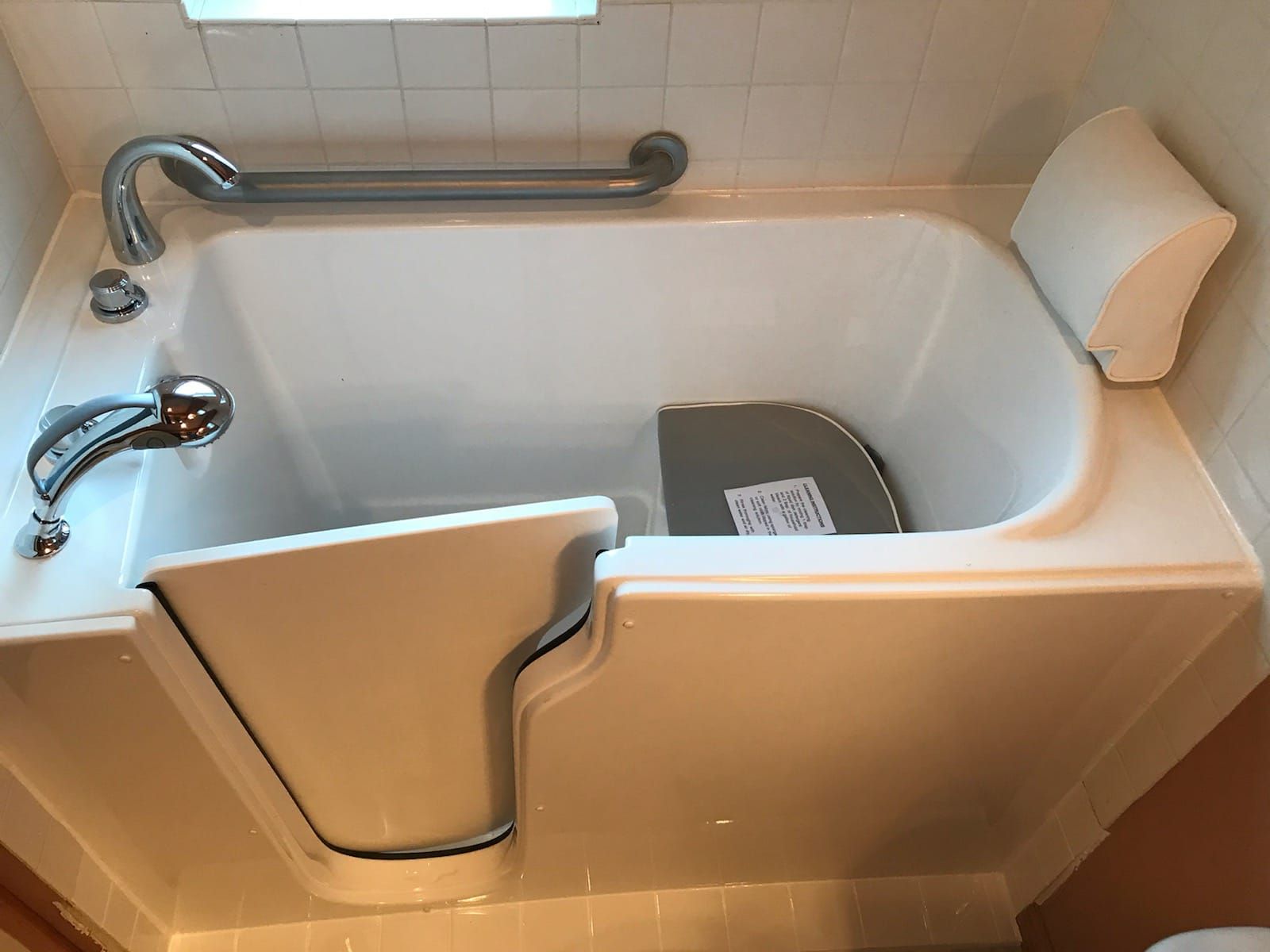 A bathtub with a door that can be opened and closed