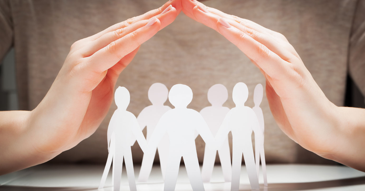 image of female hands over paper cutout of group