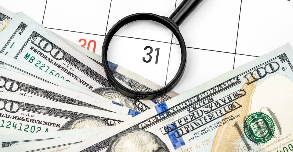 thumbnail of magnifying glass over money and calendar