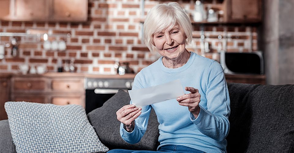 thumbnail image of retired woman holding social security check