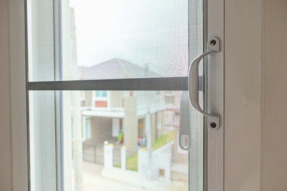 A White Window Frame Featuring a Vertical Mesh Screen — LeSands Screens & Blinds Moss Vale Pty Ltd in Moss Vale, NSW