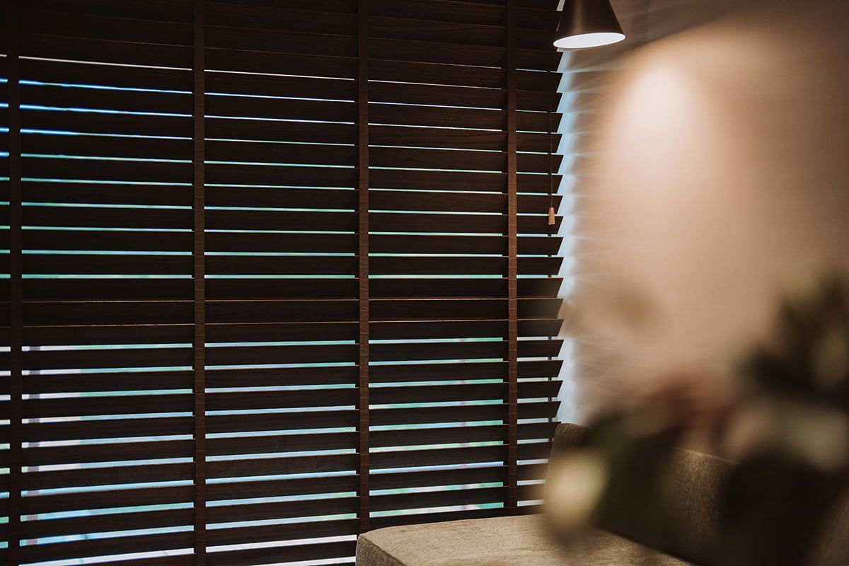 Dark Wood Blinds Partially Cover a Window — LeSands Screens & Blinds Moss Vale Pty Ltd in Moss Vale, NSW
