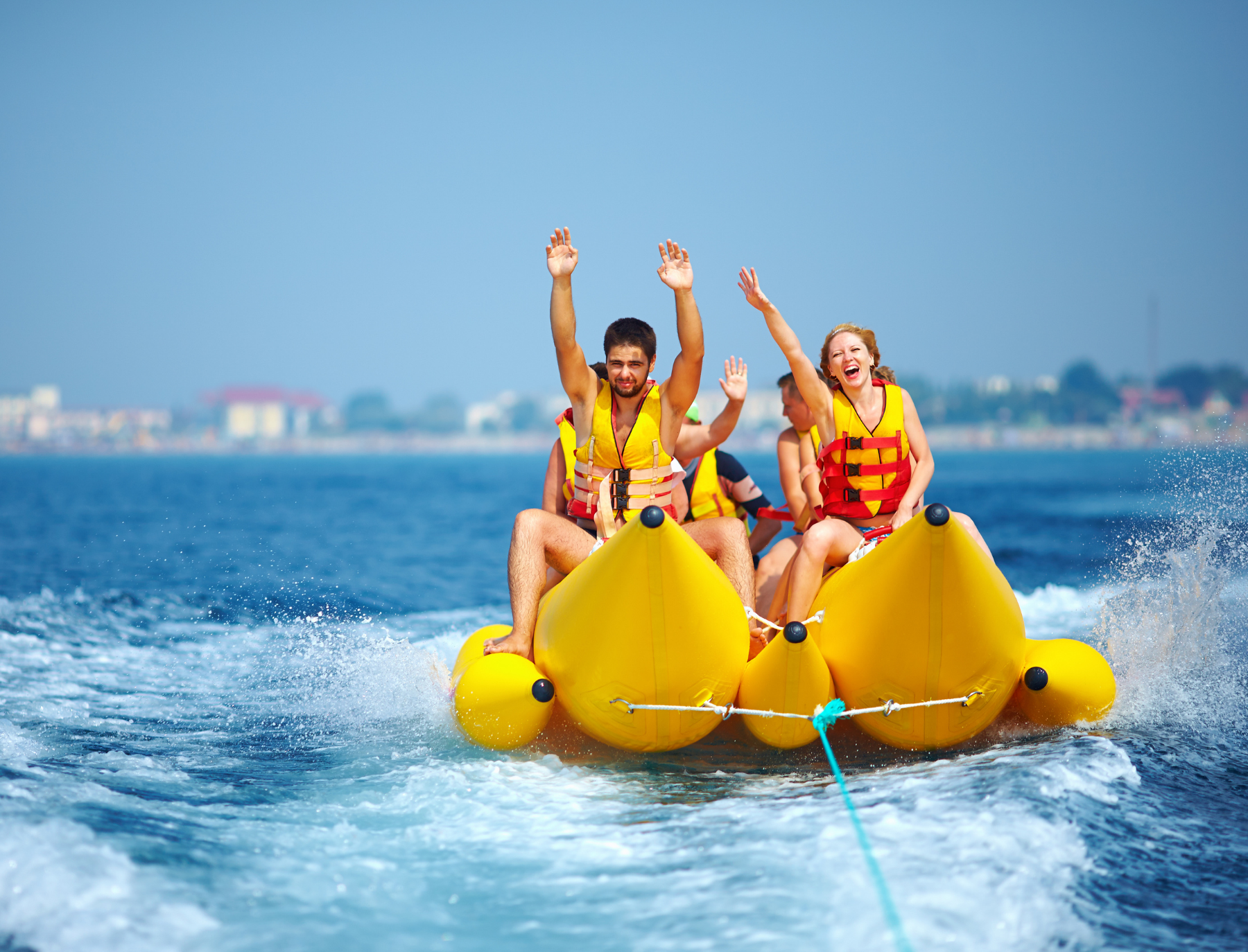 Happy people riding on a banana boat