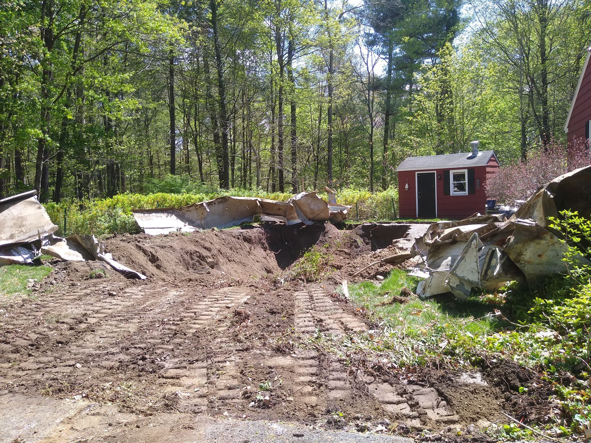Bobcat excavator dumping soil into a trench on a sunny day. Bobcat excavator dumping soil into a trench on a sunny day.