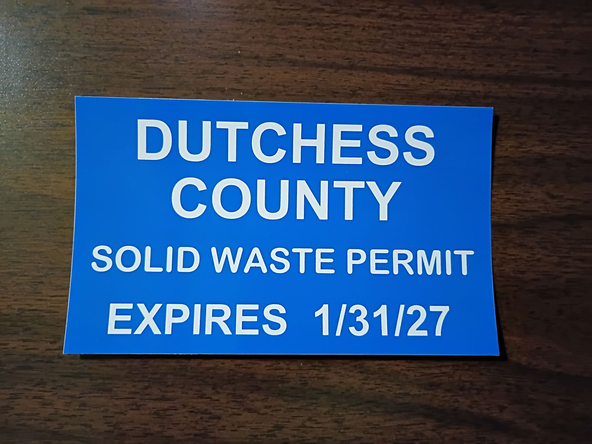 Blue Dutchess County Solid Waste Permit, expires 1/31/27, white text on blue background.