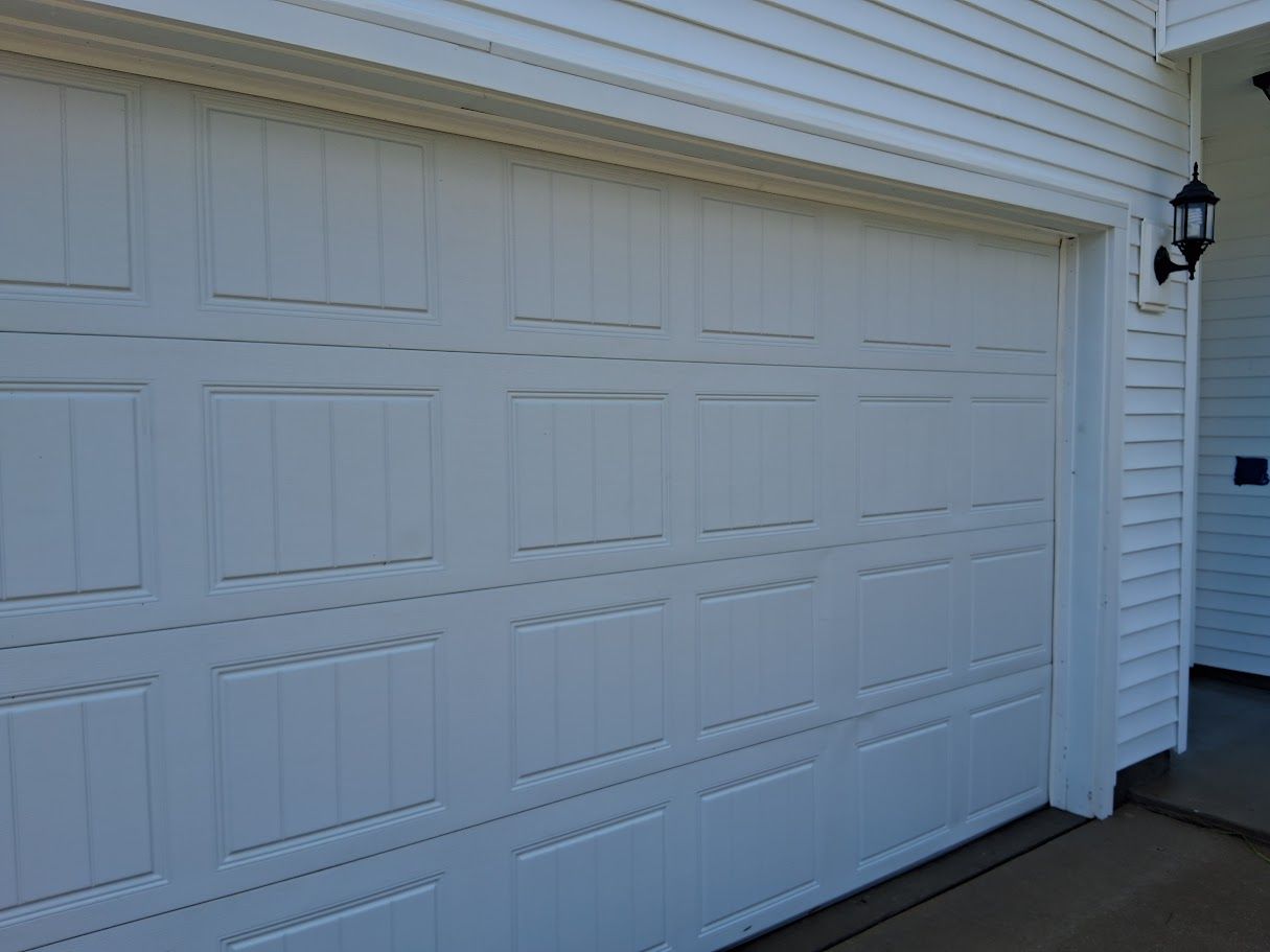 A person is using a high pressure washer to clean a tiled floor.