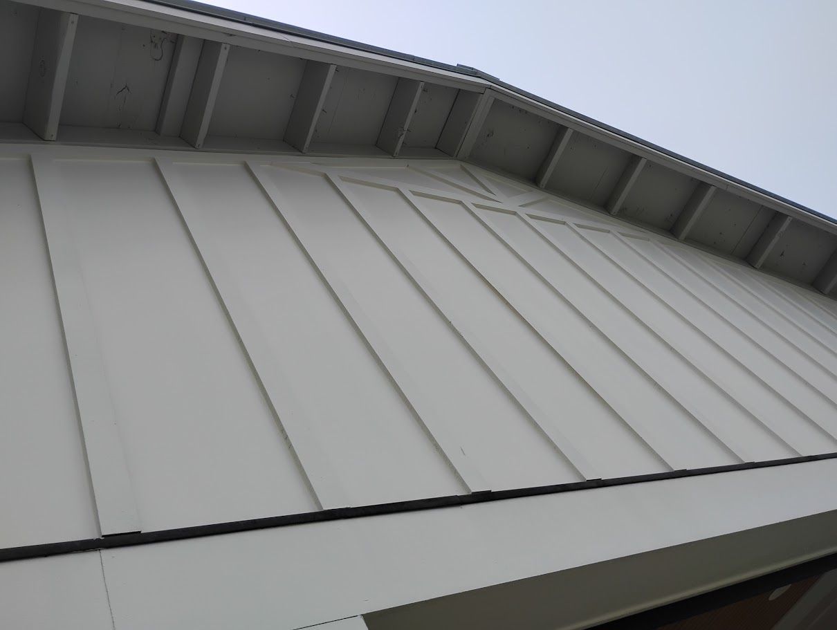 An empty parking lot with a large building in the background.