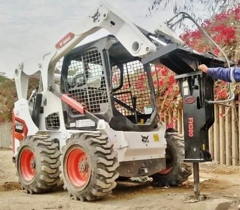 Operador inspeccionando una motoniveladora