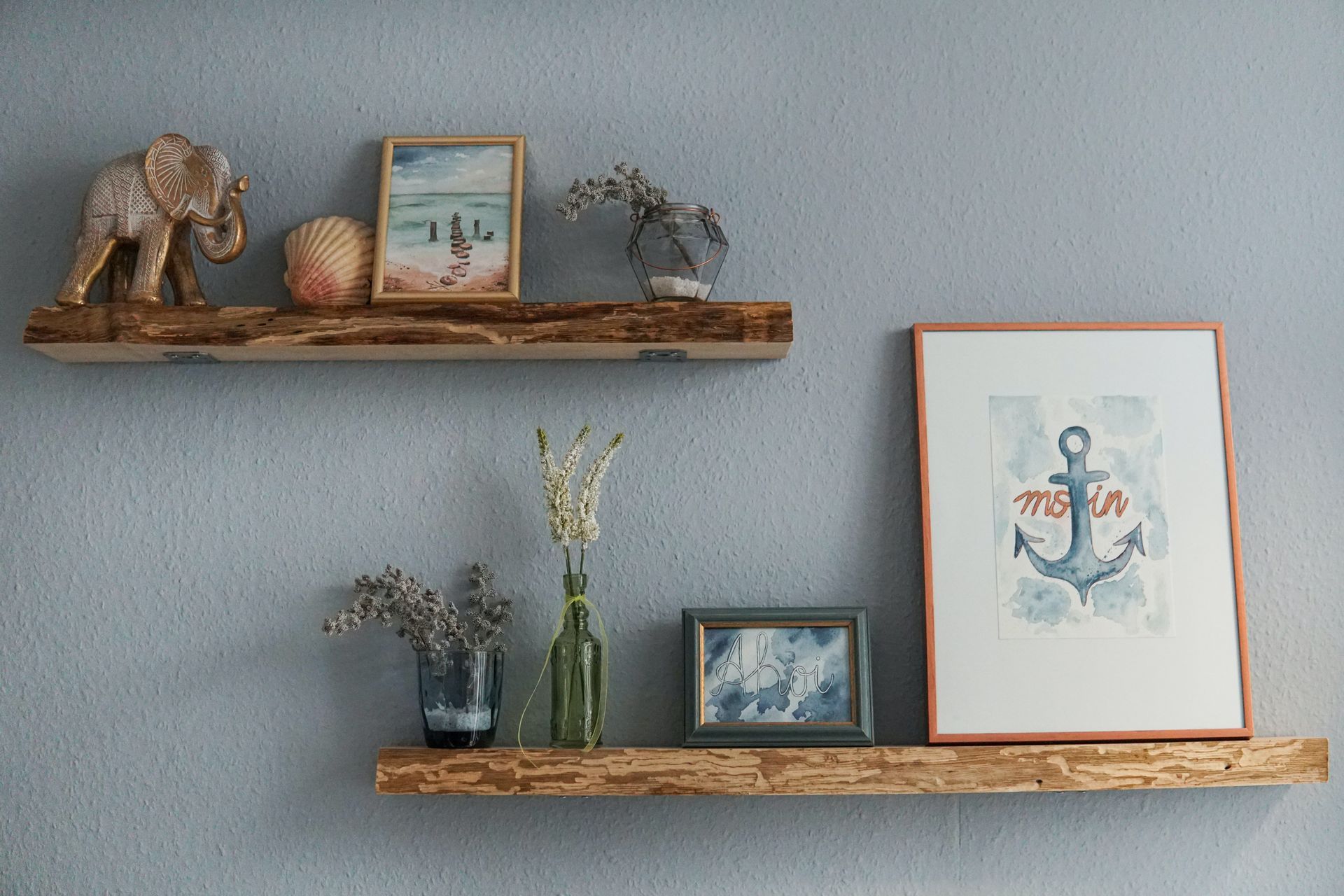 A wooden wall shelf adorned with picture frames, small vases, and decorative items.