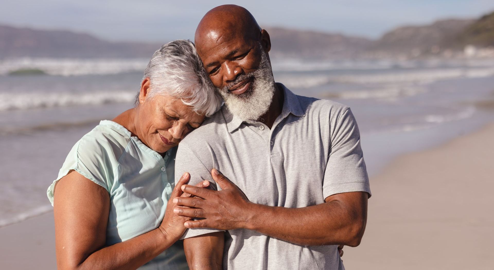 a man in a suit is comforting a woman at a funeral .