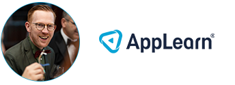 a man in a suit and tie is holding a microphone in front of an app learn logo .
