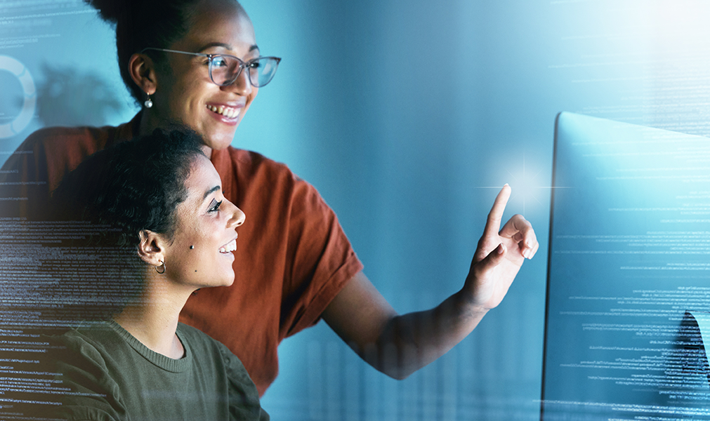 Two women looking at a computer screen.