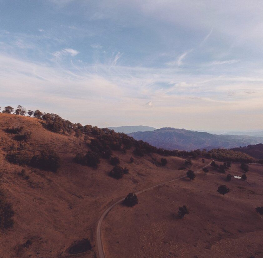 An Aerial View of A Desert Landscape with Mountains in The Background — DecoGlaze in Maitland, NSW
