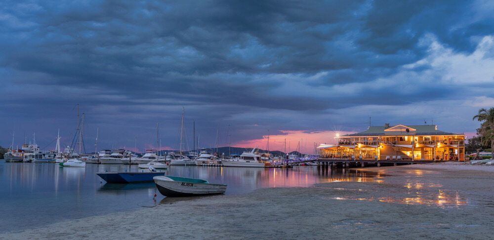 A Group of Boats Are Docked in A Harbor at Night — DecoGlaze in Port Stephens, NSW